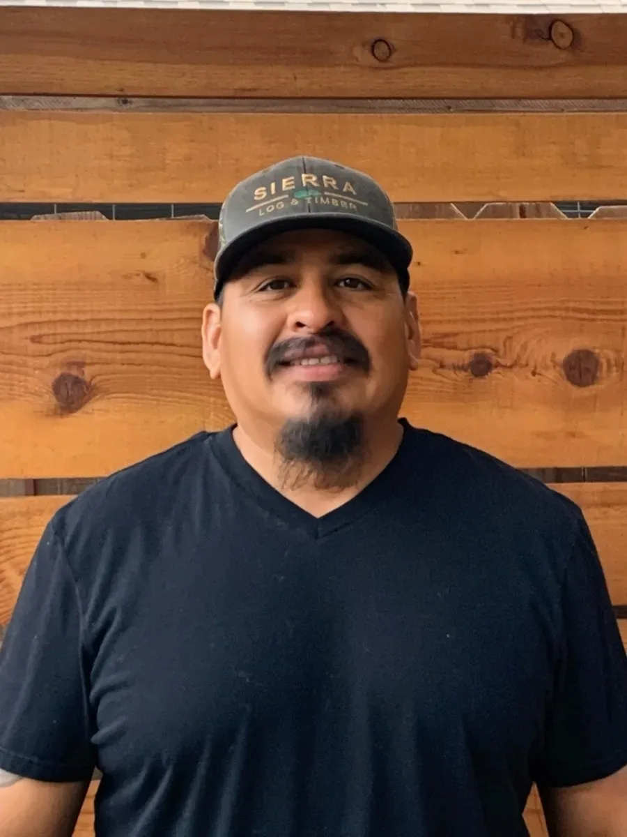 Isaac Meza Lopez in a Sierra cap, on the showroom porch.