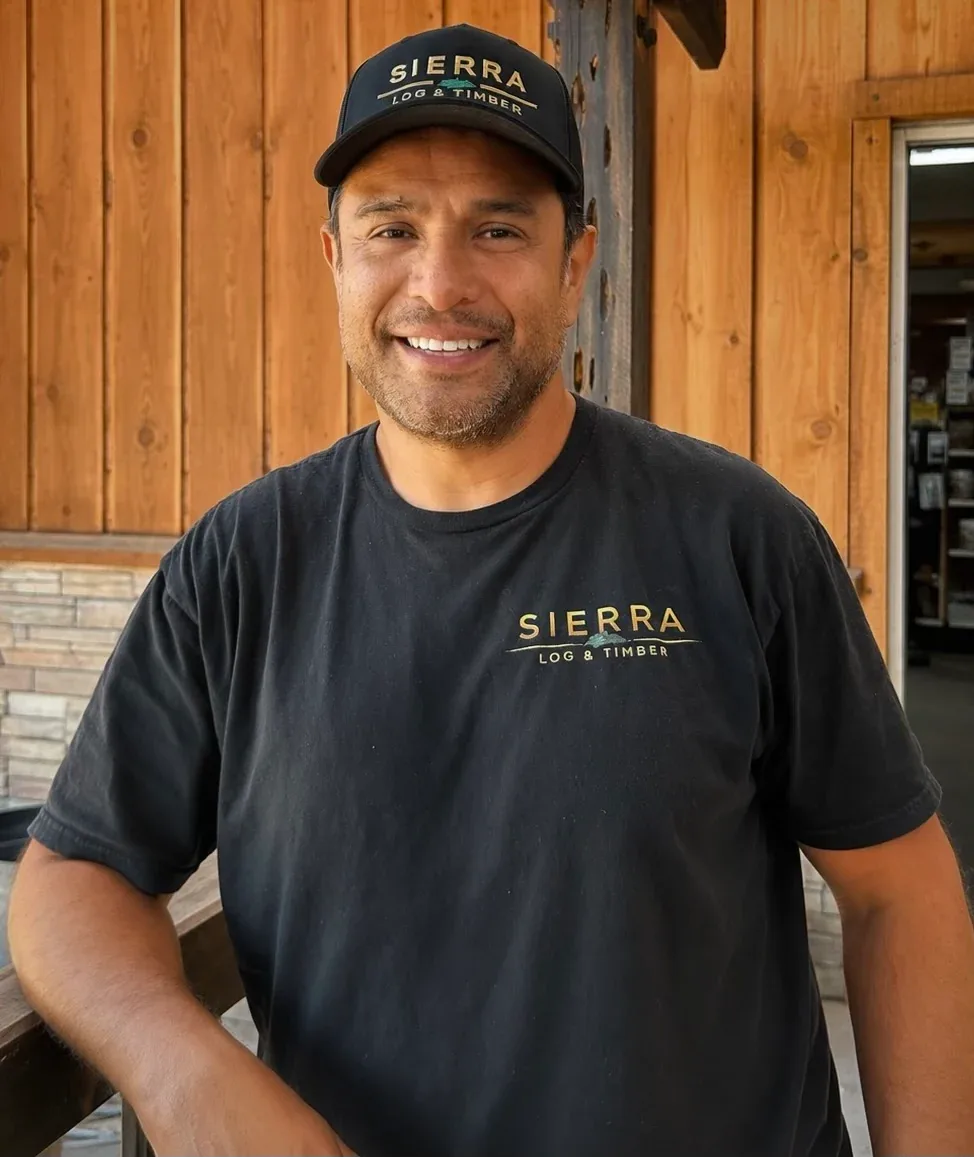 Julio Aguirre in a Sierra cap and shirt, in front of the showroom.