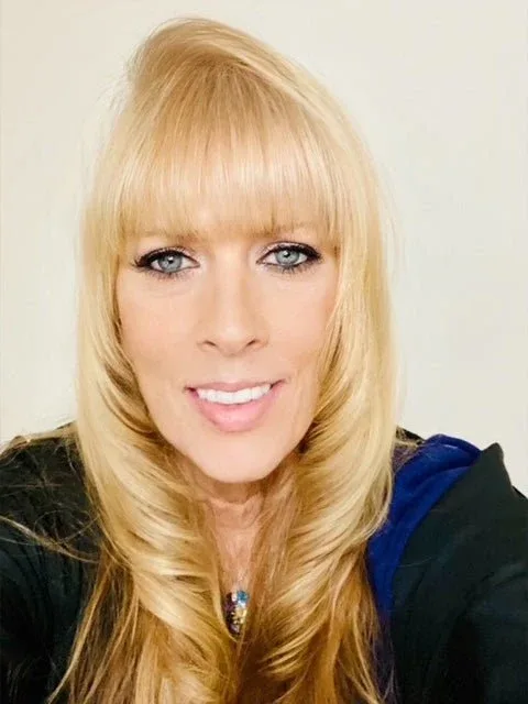 Pamela Andrews, smiling, with long blonde hair.