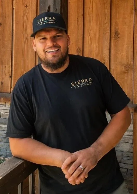 Pino Rangel in a Sierra cap and shirt, on the showroom porch.