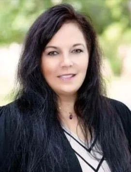 Tonia Hanson, smiling, with long dark hair.