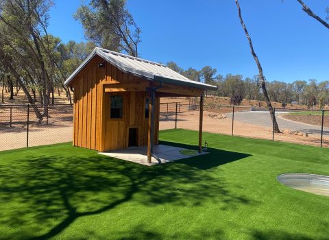 A custom shade structure with green grass garden